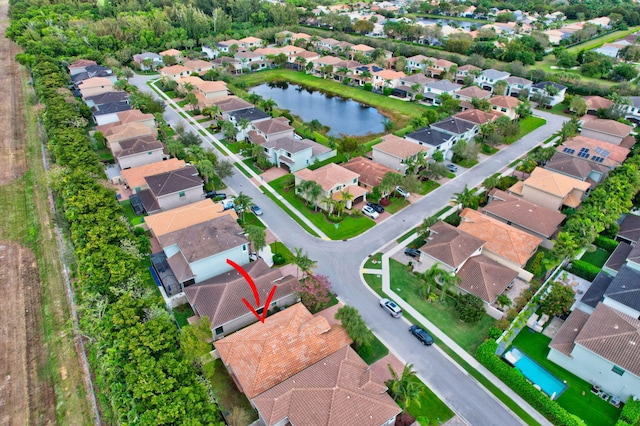 birds eye view of property featuring a water view and a residential view