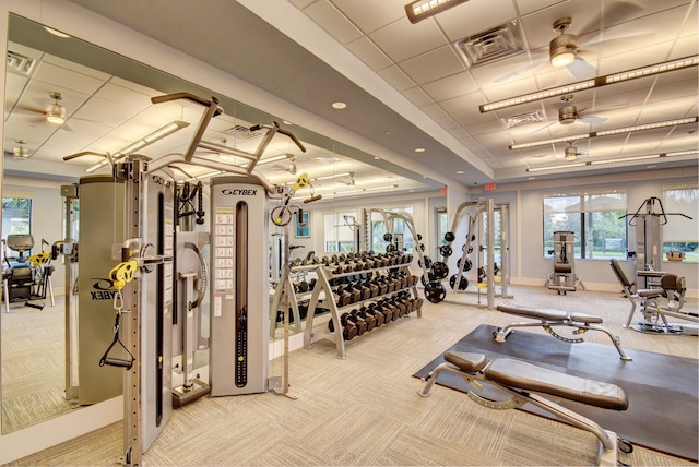 gym with light colored carpet, visible vents, and baseboards