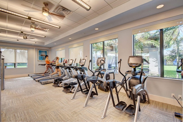 workout area with ceiling fan, visible vents, baseboards, and carpet flooring