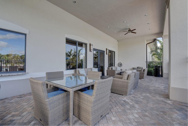 view of patio with outdoor dining space and a ceiling fan