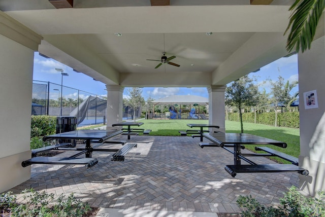 view of patio / terrace with ceiling fan, fence, and outdoor dining area