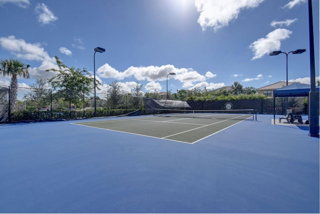 view of tennis court with fence