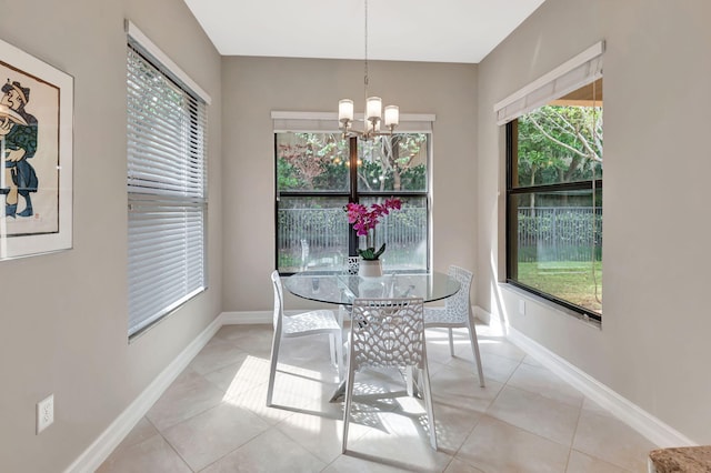 dining area featuring light tile patterned floors, baseboards, and a chandelier