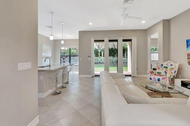 living room featuring ceiling fan, light tile patterned floors, recessed lighting, visible vents, and baseboards