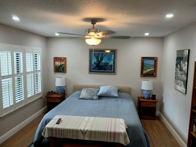 bedroom with recessed lighting, baseboards, and wood finished floors