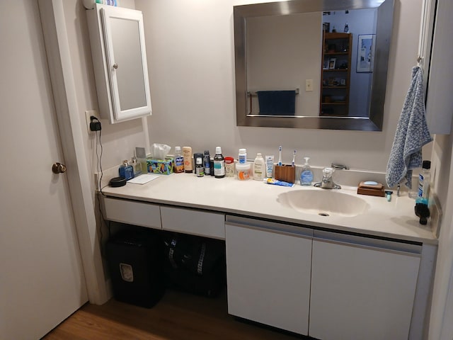 bathroom featuring wood finished floors and vanity