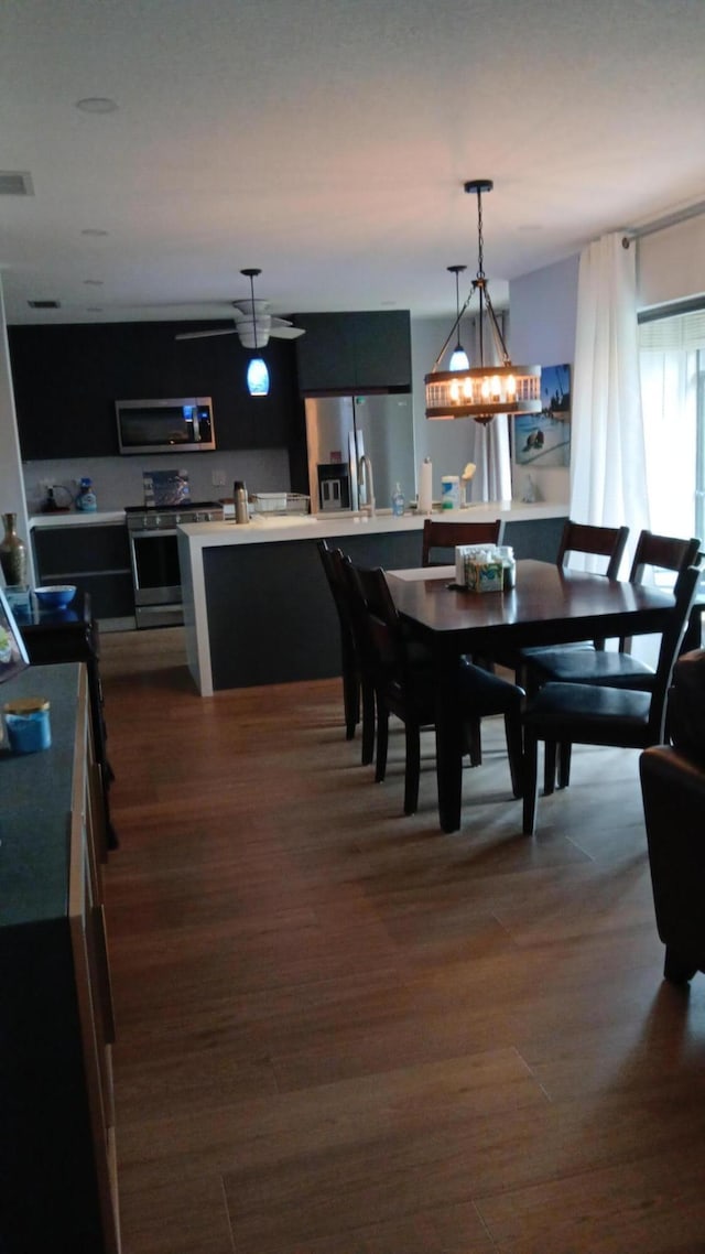 dining room featuring dark wood-style flooring and visible vents