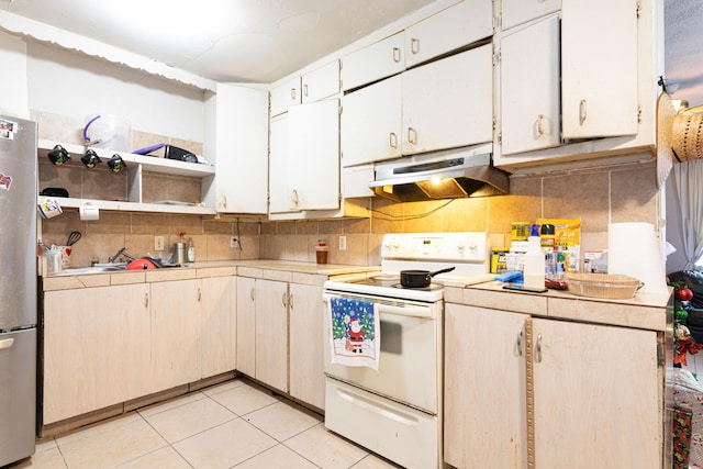 kitchen featuring under cabinet range hood, backsplash, light countertops, and electric stove