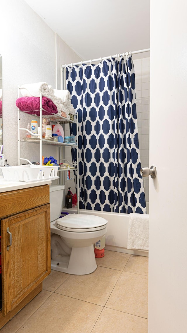 full bathroom featuring toilet, tile patterned flooring, shower / bath combo, and vanity