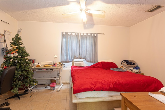 tiled bedroom with a ceiling fan, a textured ceiling, visible vents, and cooling unit