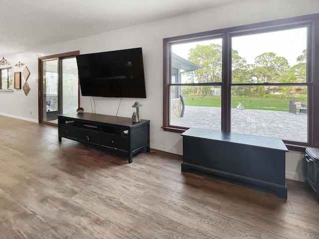 living area with wood finished floors and baseboards