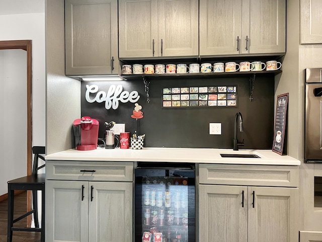 bar featuring wall oven, beverage cooler, a sink, and bar area