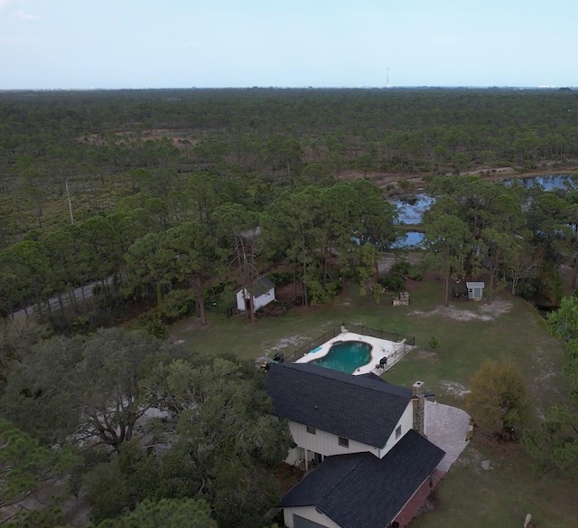 aerial view featuring a water view and a view of trees