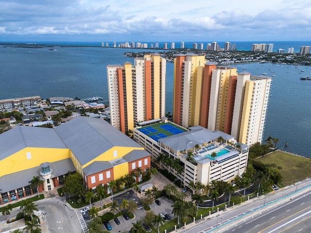 birds eye view of property with a water view and a view of city