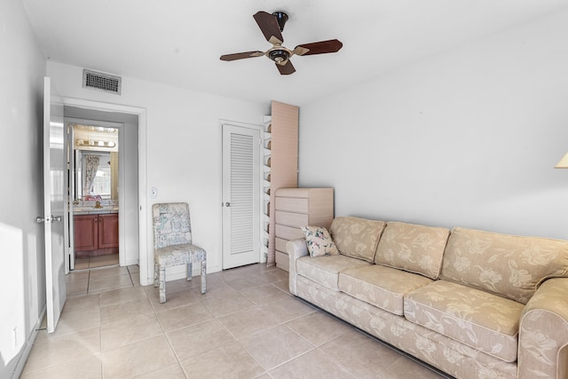 living room featuring light tile patterned floors, ceiling fan, and visible vents