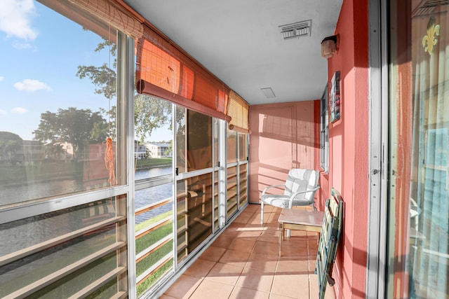 balcony featuring a water view and visible vents