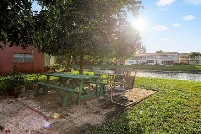 view of yard featuring a water view and a patio area