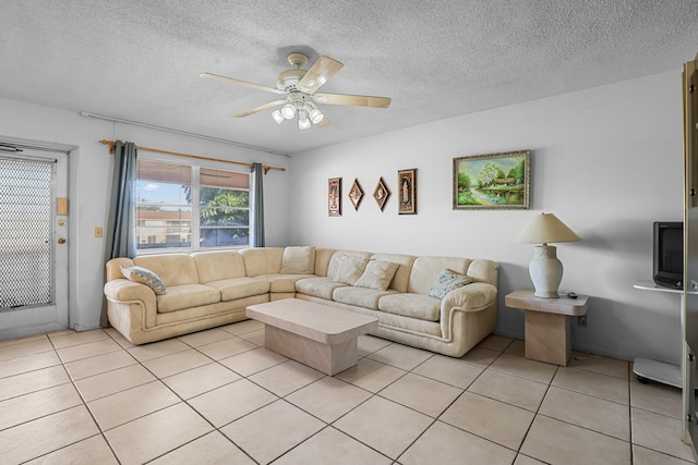 living area with a ceiling fan, a textured ceiling, and light tile patterned floors