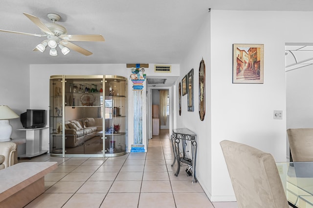 hallway with visible vents and light tile patterned floors