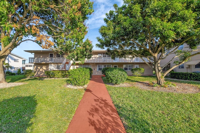 view of front of property featuring a front lawn and stucco siding