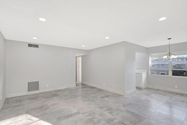 unfurnished room featuring an inviting chandelier, visible vents, and recessed lighting