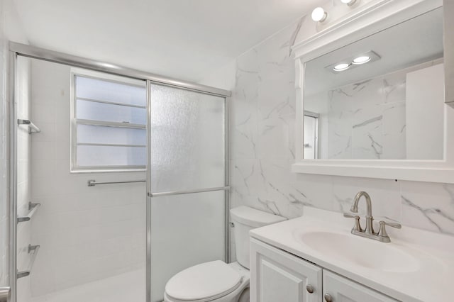 full bath with toilet, a shower stall, and vanity