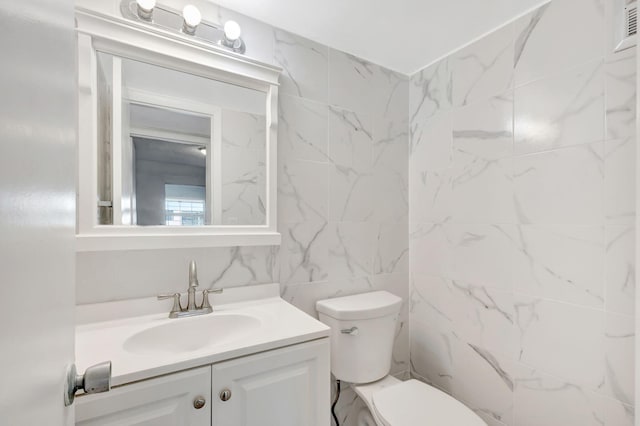 bathroom with toilet and vanity