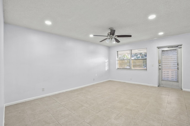 spare room featuring recessed lighting, ceiling fan, a textured ceiling, and baseboards