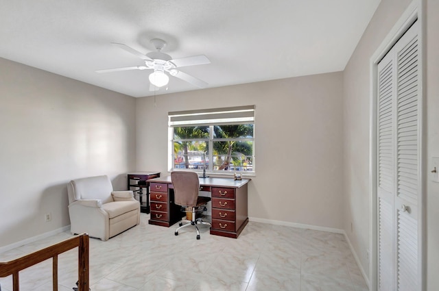 office with a ceiling fan and baseboards