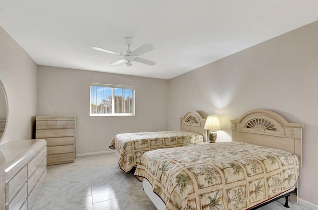 bedroom featuring a ceiling fan and baseboards