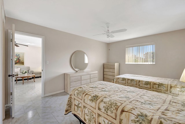 bedroom with marble finish floor, ceiling fan, and baseboards
