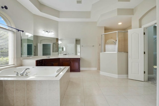 full bath featuring vanity, baseboards, a stall shower, tile patterned flooring, and a bath