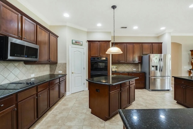 kitchen with a center island, dark stone counters, hanging light fixtures, arched walkways, and black appliances