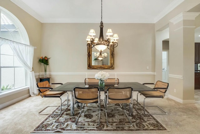 dining area with a chandelier, baseboards, ornamental molding, and carpet flooring