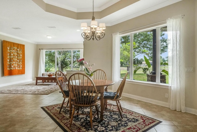 dining area with a wealth of natural light, baseboards, an inviting chandelier, and crown molding