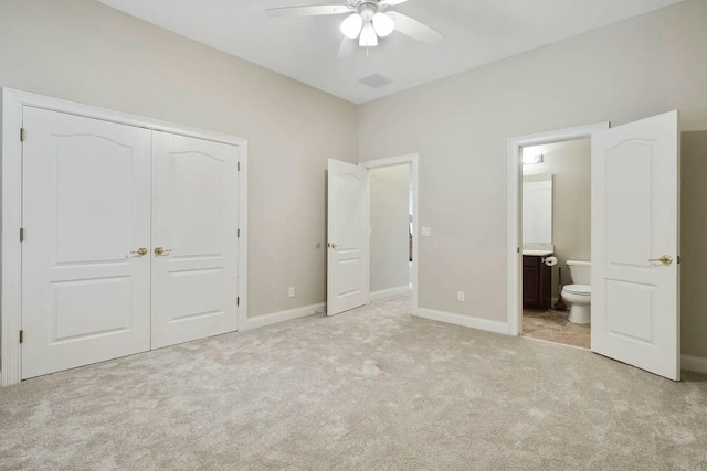 unfurnished bedroom featuring connected bathroom, ceiling fan, baseboards, carpet floors, and a closet