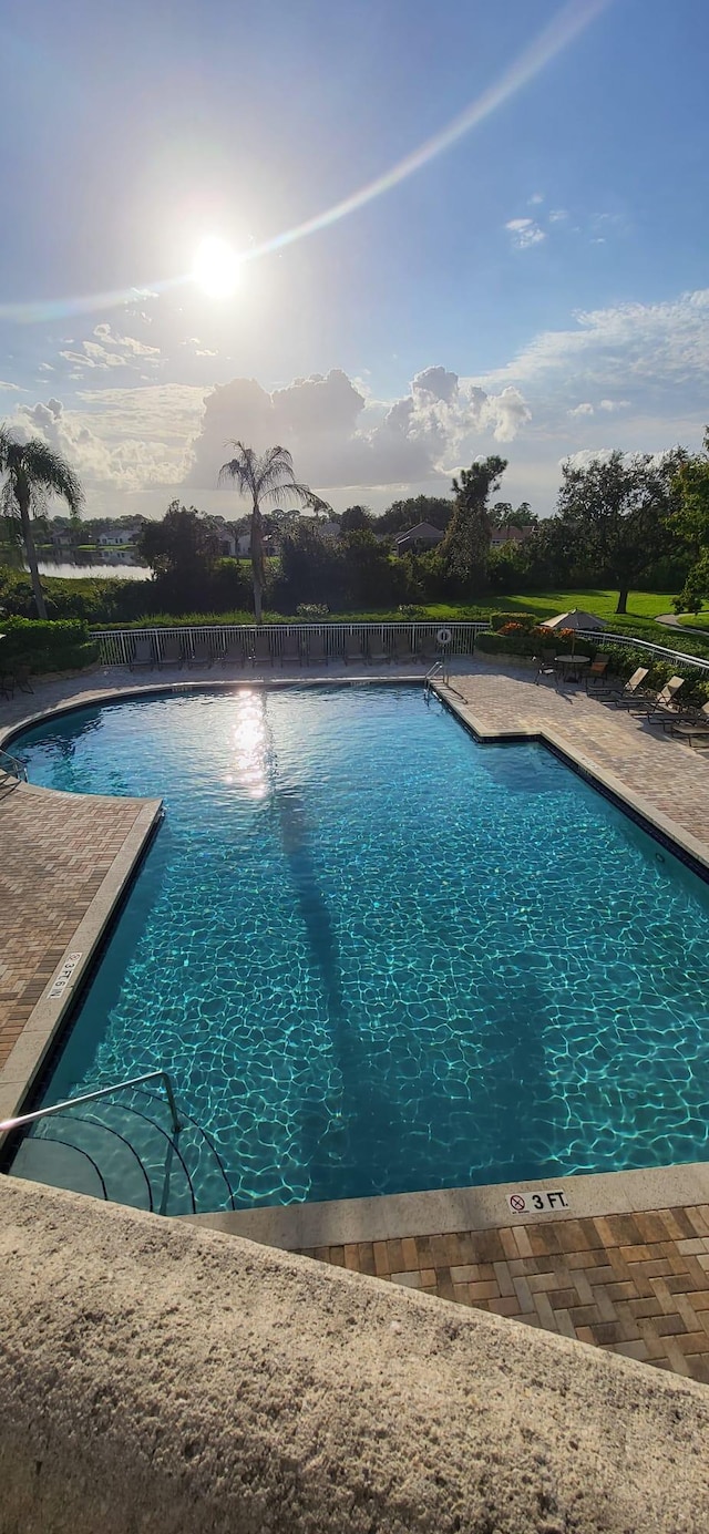 community pool with a patio area