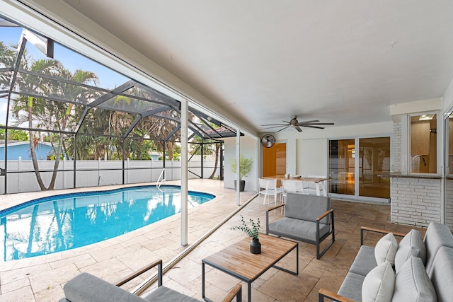 view of pool featuring a ceiling fan, a fenced in pool, a lanai, fence, and a patio area