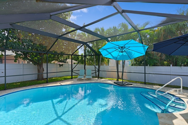 view of swimming pool featuring a lanai, a fenced backyard, and a fenced in pool