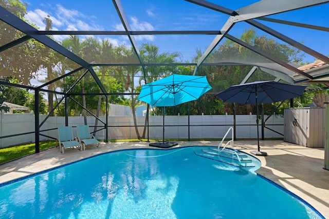 view of swimming pool featuring a fenced in pool, a lanai, a fenced backyard, and a patio