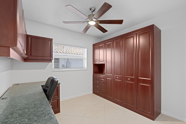 office with light tile patterned flooring, a ceiling fan, and baseboards