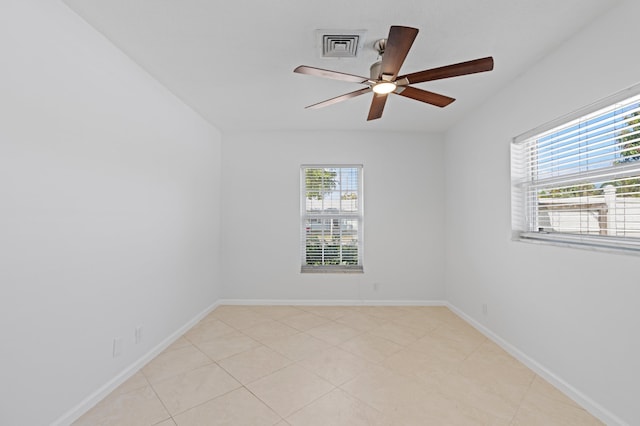 empty room featuring baseboards, visible vents, and ceiling fan