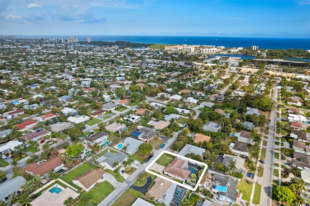 birds eye view of property with a water view and a residential view