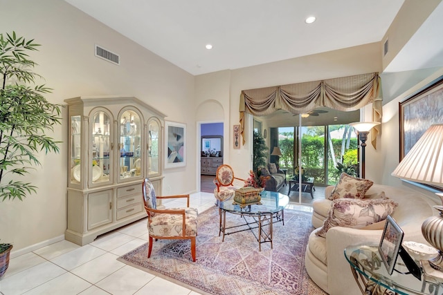 living room with light tile patterned floors, high vaulted ceiling, recessed lighting, visible vents, and baseboards