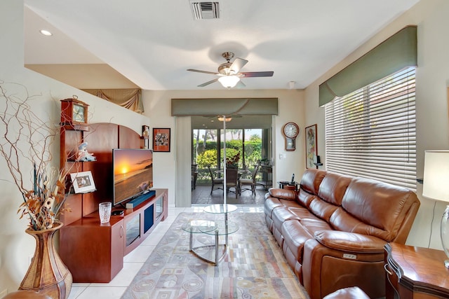 living room with visible vents, ceiling fan, and light tile patterned flooring