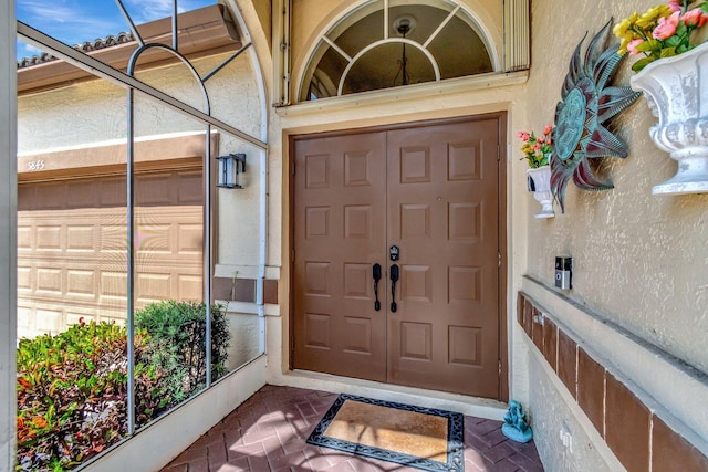 entrance to property featuring stucco siding