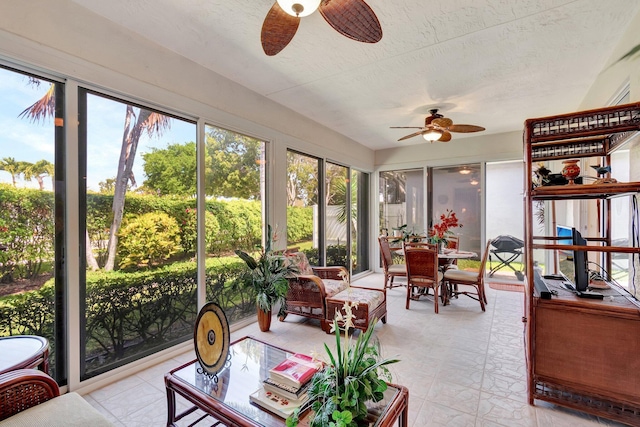 sunroom / solarium with a ceiling fan