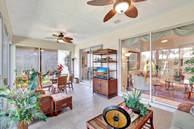 sunroom / solarium with ceiling fan and visible vents