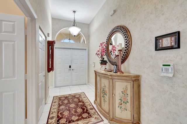 entryway featuring light tile patterned floors and wallpapered walls