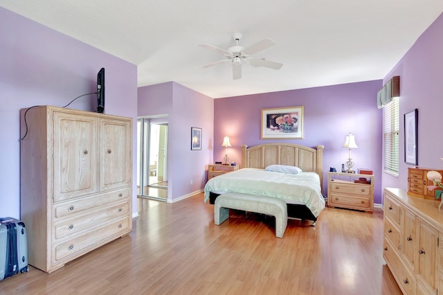 bedroom featuring light wood-type flooring, a ceiling fan, and baseboards